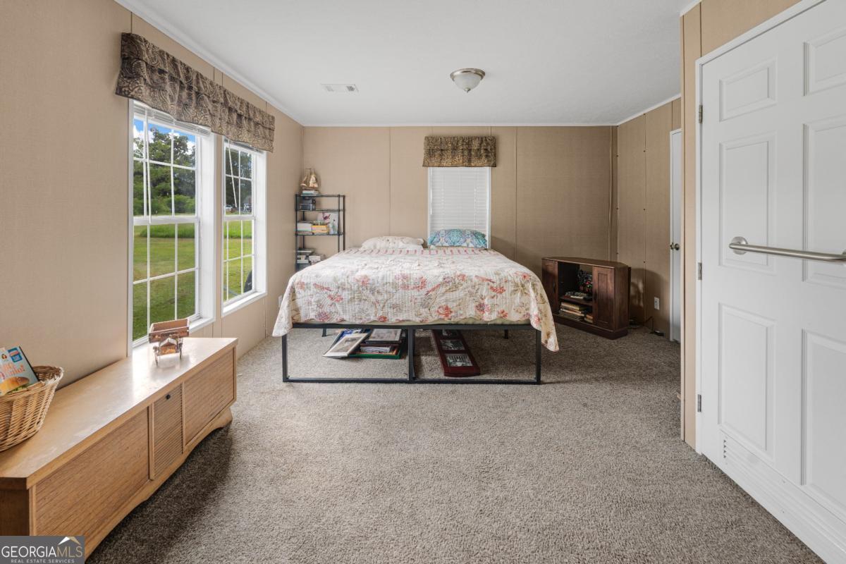 82 Harris Road Baxley, GA 31513 - Photo 21 of 23 a bed room with a bed and a large window