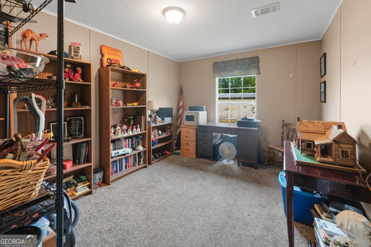 82 Harris Road Baxley, GA 31513 - Photo 22 of 23 a livingroom with workspace and a window