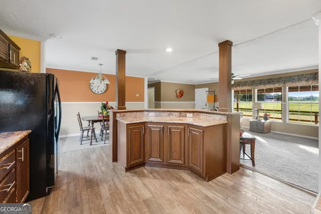 a kitchen with stainless steel appliances granite countertop a stove and a wooden floors
