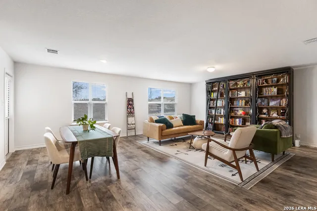 a living room with furniture and a book shelf