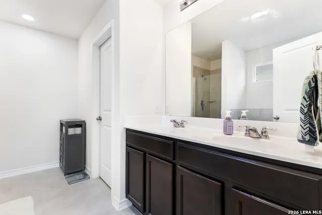 a bathroom with a double vanity sink and mirror