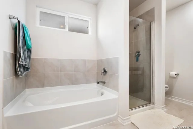 a bathroom with a bathtub and a shower