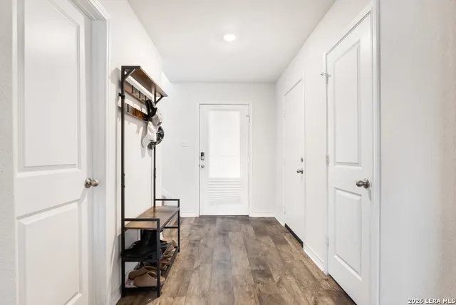 a view of a room with wooden floor and furniture