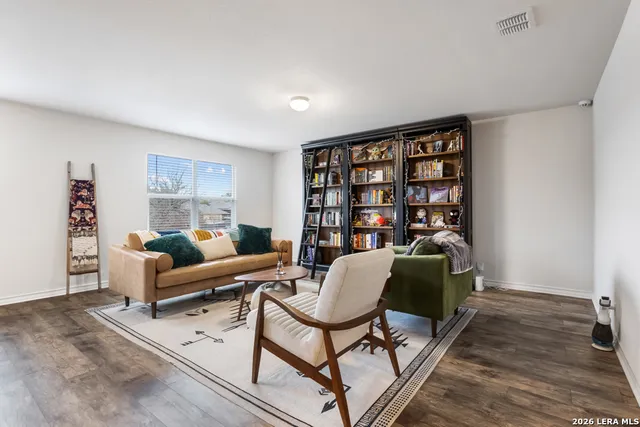 a living room with furniture and a bookshelf