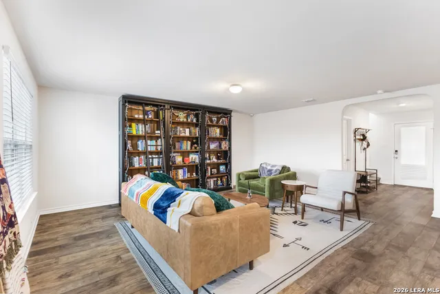 a living room with furniture and a book shelf