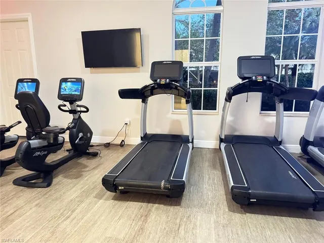 a living room with furniture pool table and flat screen tv