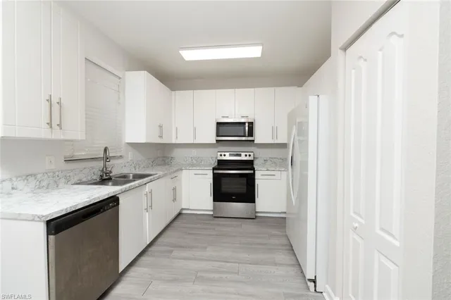 a kitchen with a sink stove and microwave