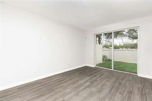 a view of wooden floor and windows in a room