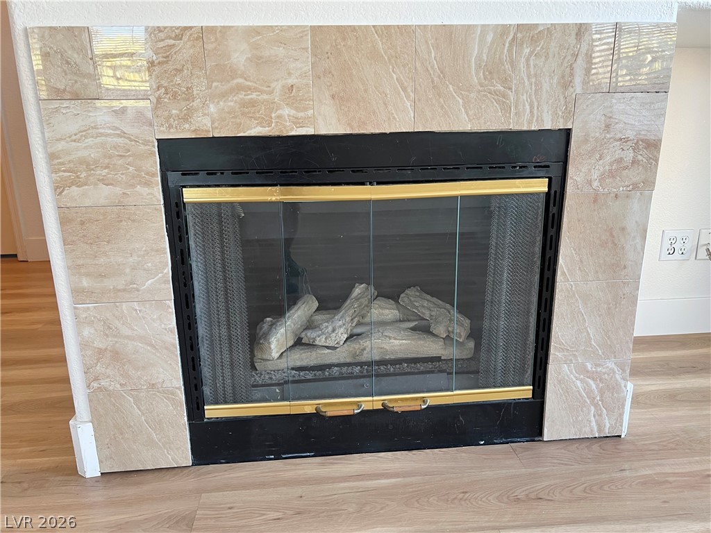 9708 Ridge Creek Place Las Vegas, NV 89134 - Photo 14 of 43 A refined fireplace, featuring an elegant tile surround and a convenient glass screen.