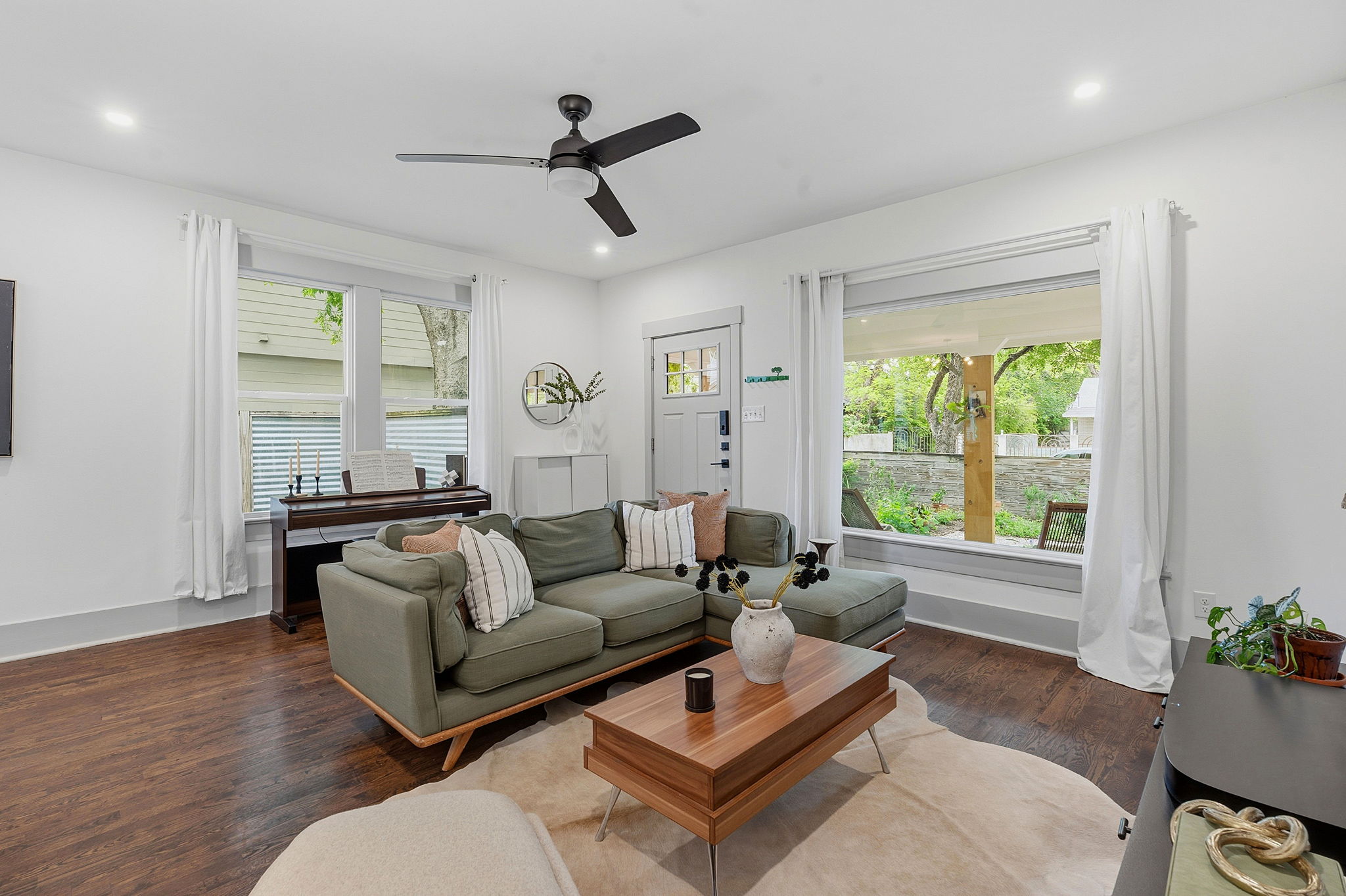 1122 Gunter Street Austin, TX 78702 - Photo 2 of 23 The living area features wood flooring, recessed lighting, and a ceiling fan