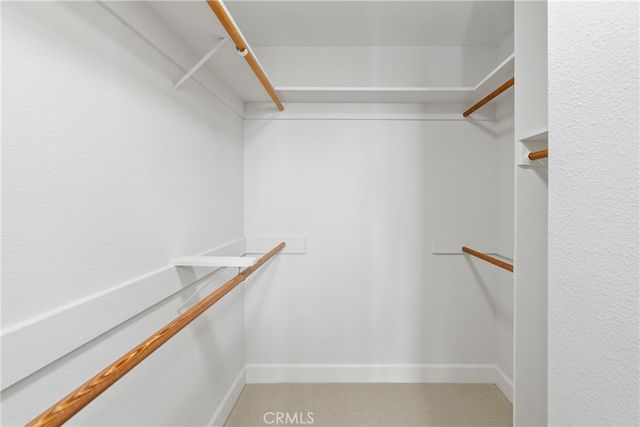 a bedroom with a bed a mirror and a window