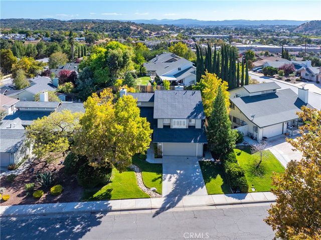 a view of a patio with a table and chairs next to a yard