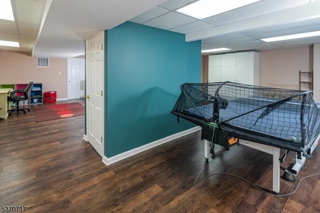 a room with wooden floor and furniture