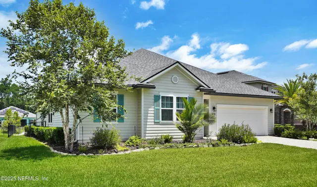 a front view of a house with a garden and yard
