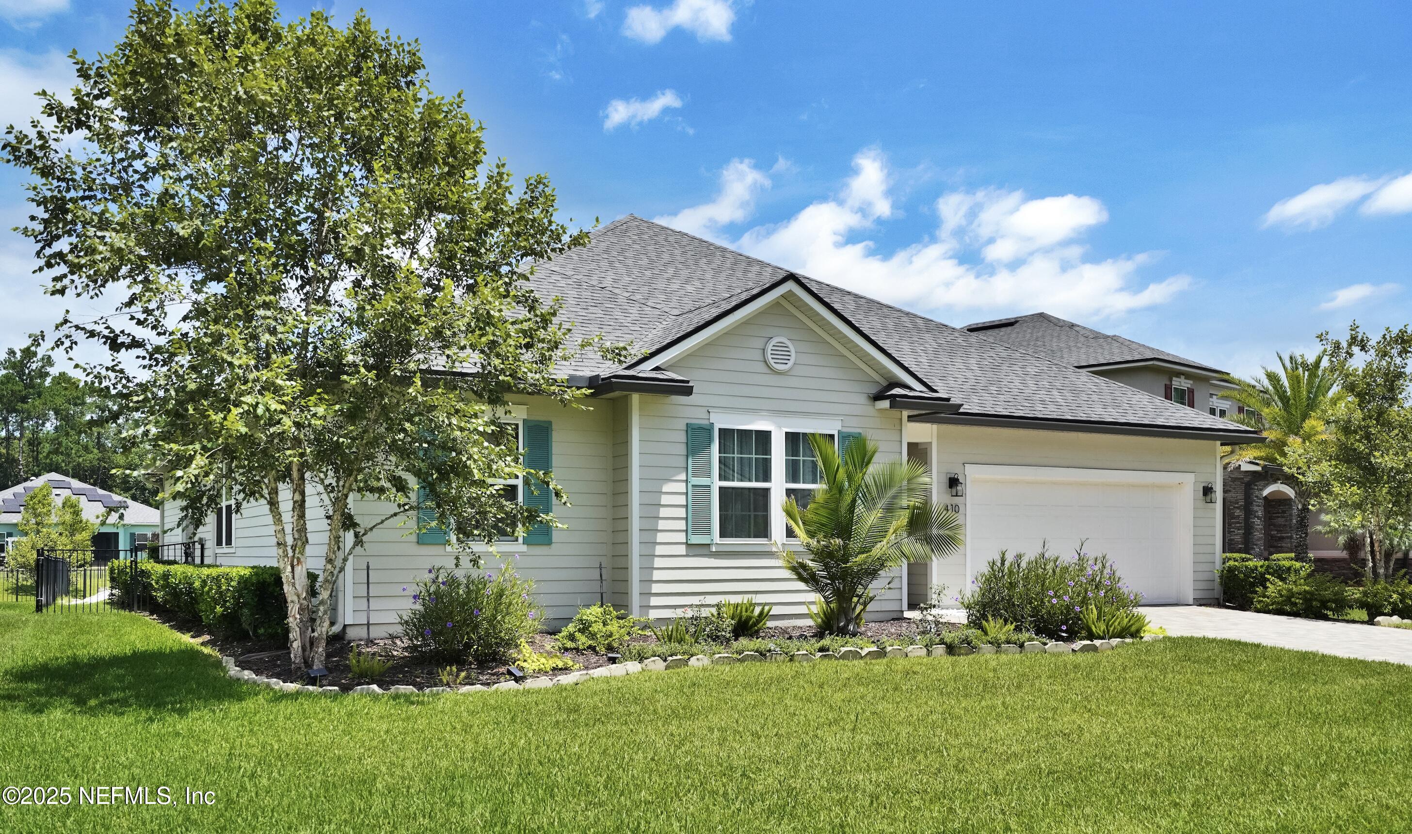 410 Downs Corner Road St. Augustine, FL 32092 - Photo 1 of 45 a front view of a house with a garden and yard