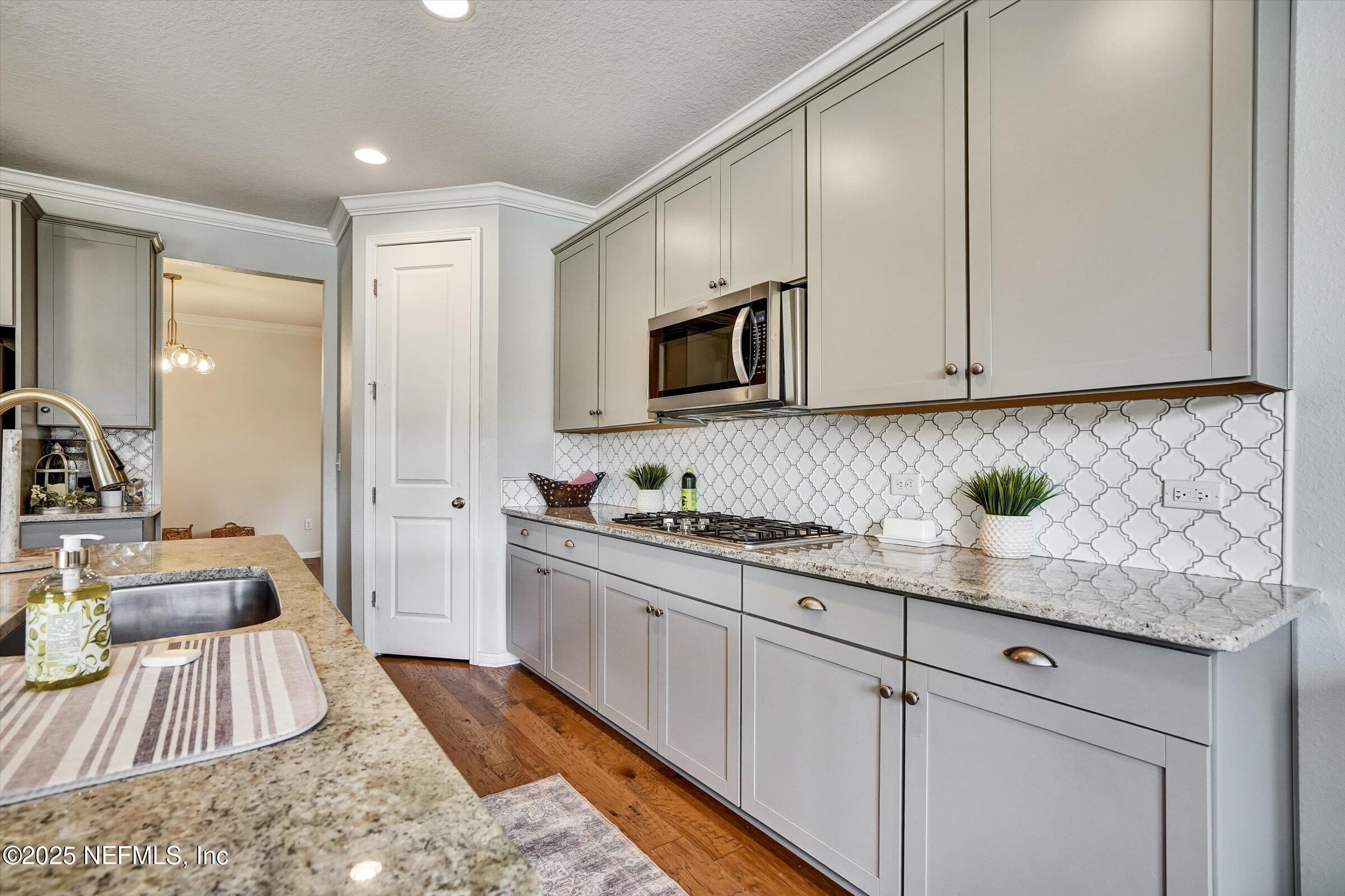 410 Downs Corner Road St. Augustine, FL 32092 - Photo 12 of 45 a kitchen with stainless steel appliances granite countertop a sink a stove and cabinets