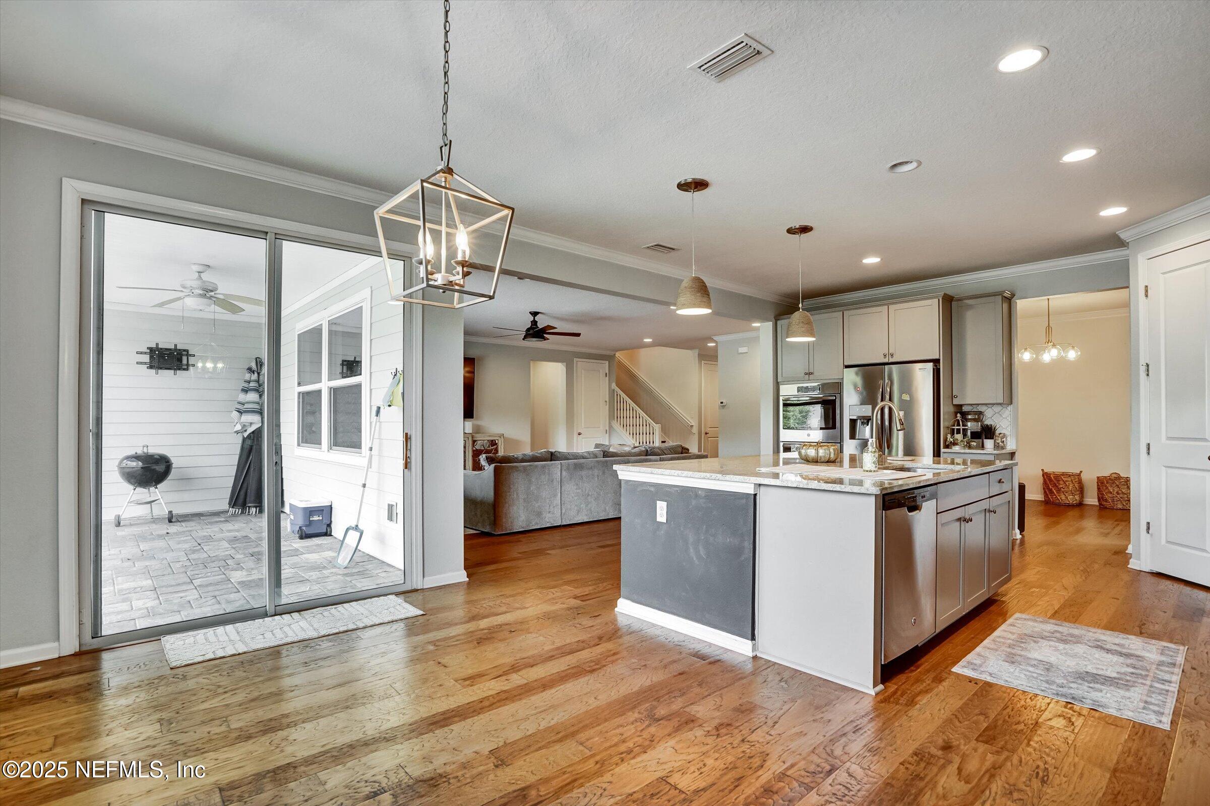410 Downs Corner Road St. Augustine, FL 32092 - Photo 15 of 45 a kitchen with stainless steel appliances granite countertop a stove and refrigerator