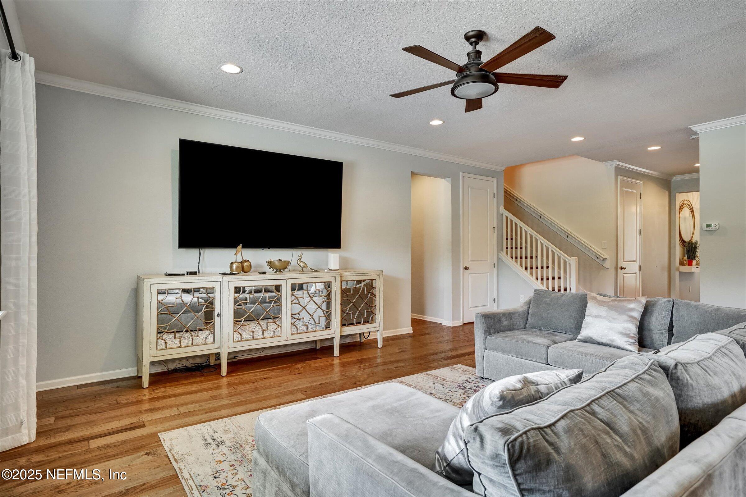 410 Downs Corner Road St. Augustine, FL 32092 - Photo 18 of 45 a living room with furniture and a flat screen tv