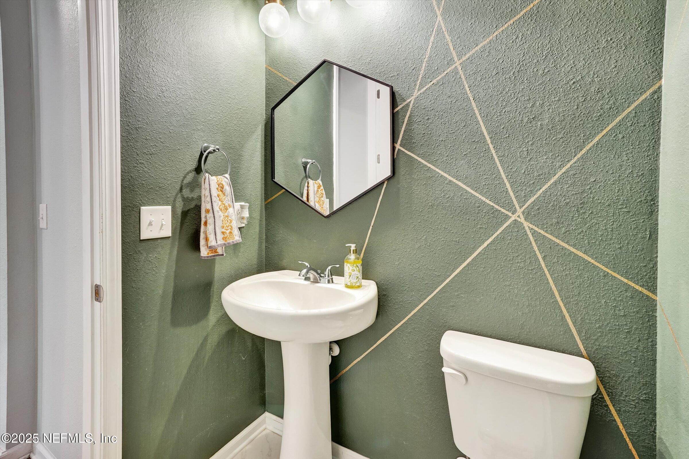 410 Downs Corner Road St. Augustine, FL 32092 - Photo 23 of 45 a bathroom with a sink toilet and mirror