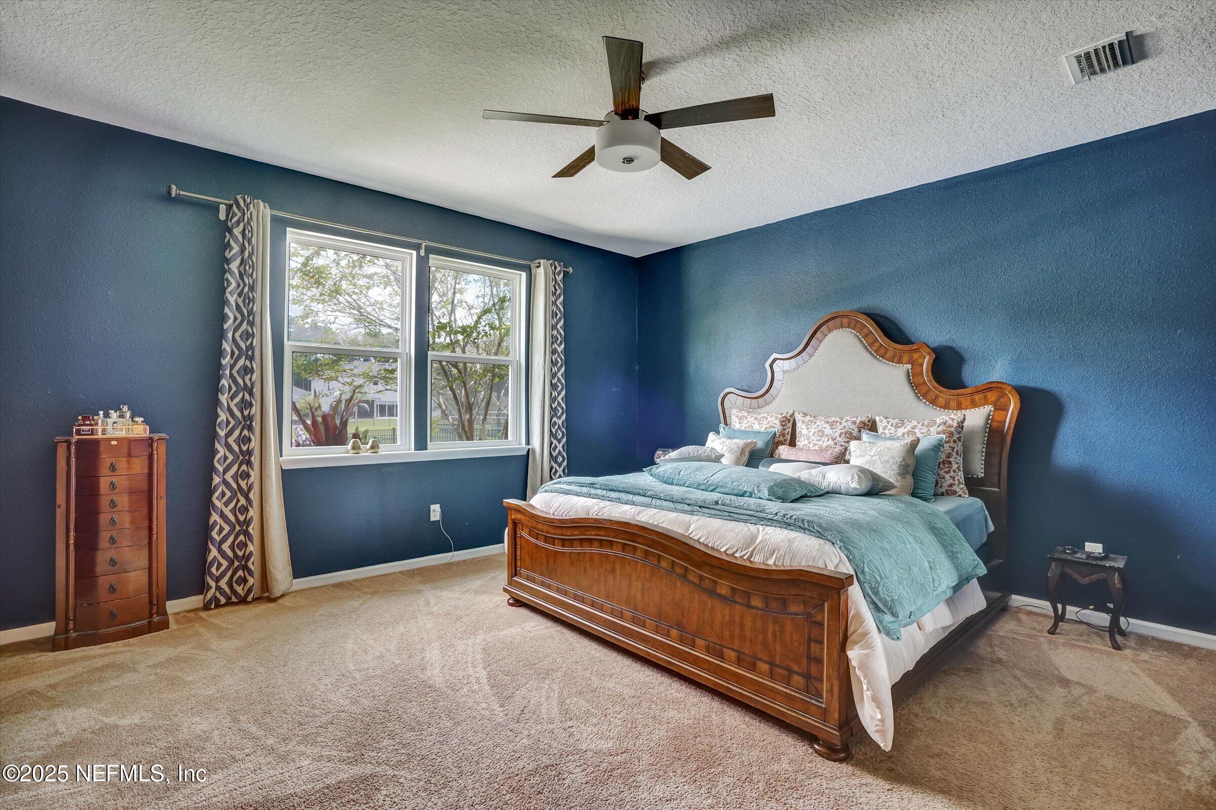 410 Downs Corner Road St. Augustine, FL 32092 - Photo 25 of 45 a bed sitting in a spacious bedroom next to a window