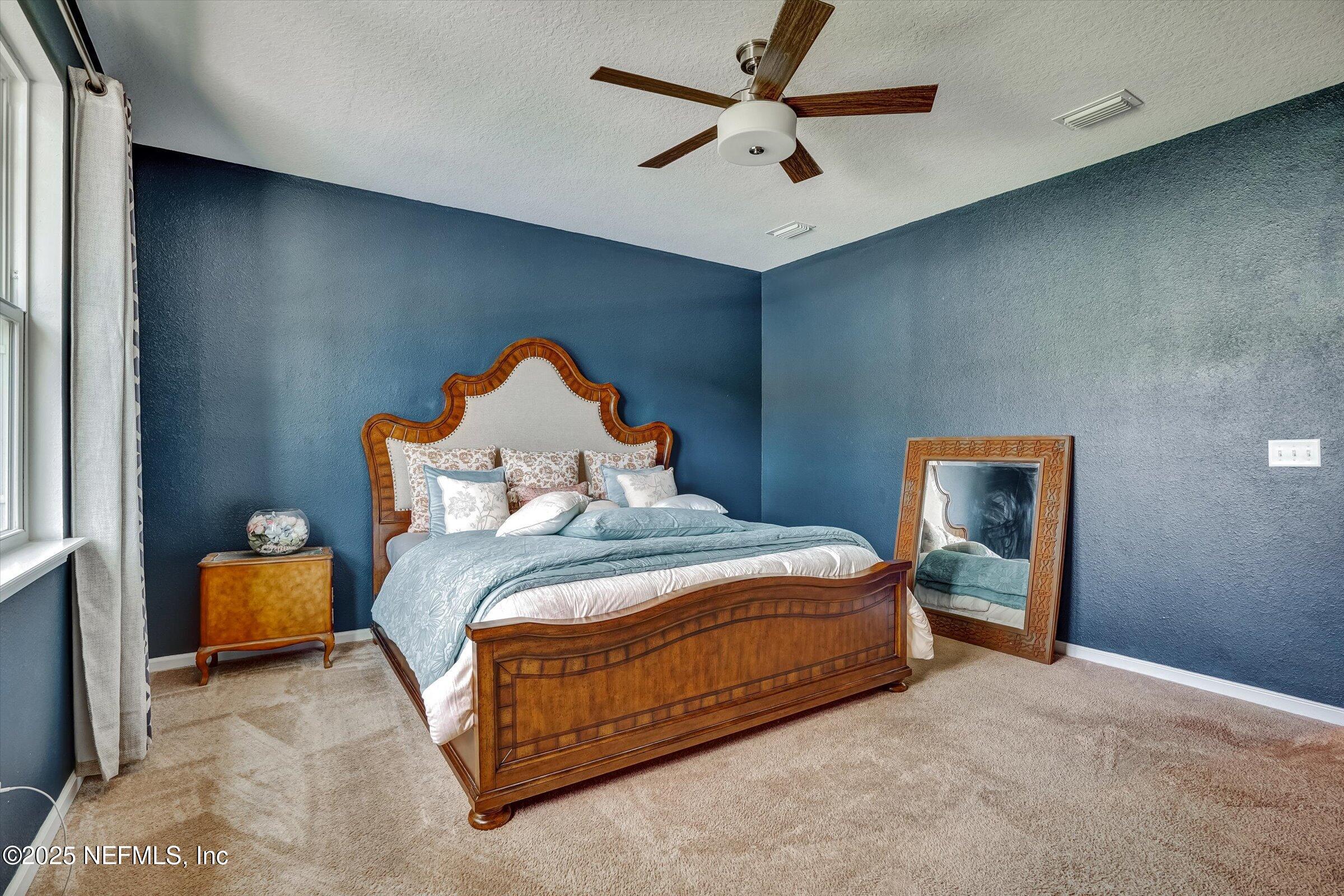 410 Downs Corner Road St. Augustine, FL 32092 - Photo 26 of 45 a bedroom with a bed and a ceiling fan