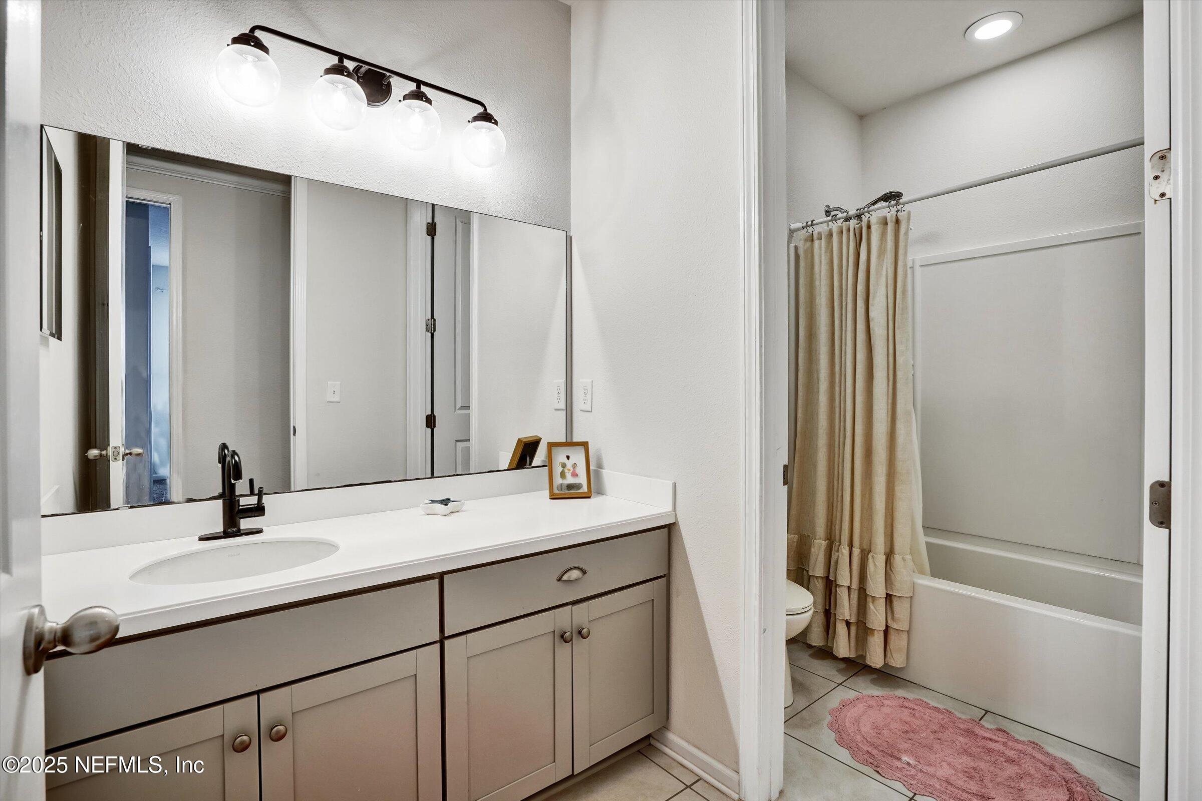 410 Downs Corner Road St. Augustine, FL 32092 - Photo 29 of 45 a bathroom with a double vanity sink mirror and shower