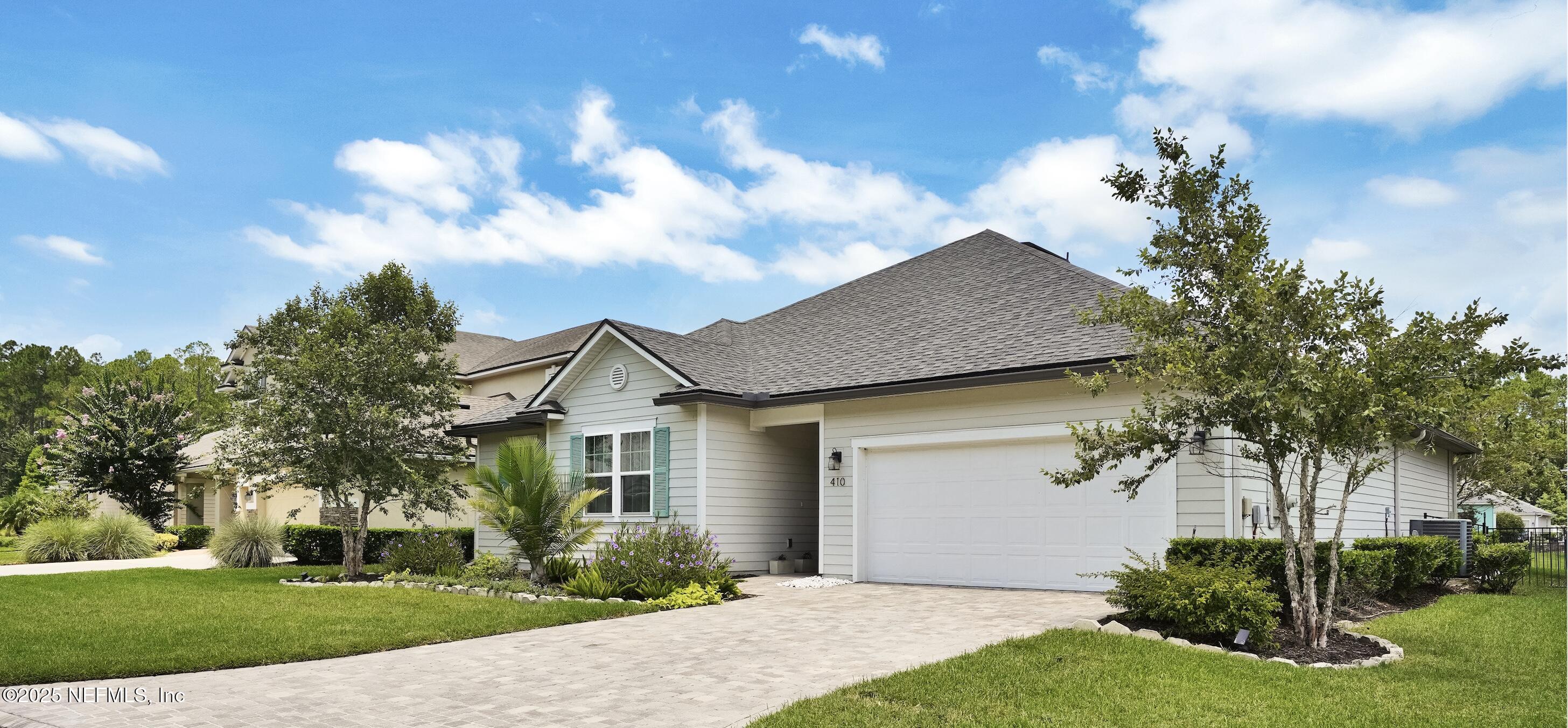 410 Downs Corner Road St. Augustine, FL 32092 - Photo 3 of 45 a front view of a house with a yard and potted plants