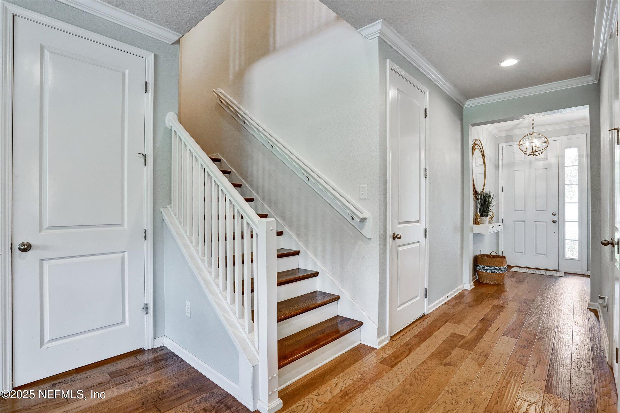 410 Downs Corner Road St. Augustine, FL 32092 - Photo 6 of 45 a view of a hallway with wooden floor and staircase