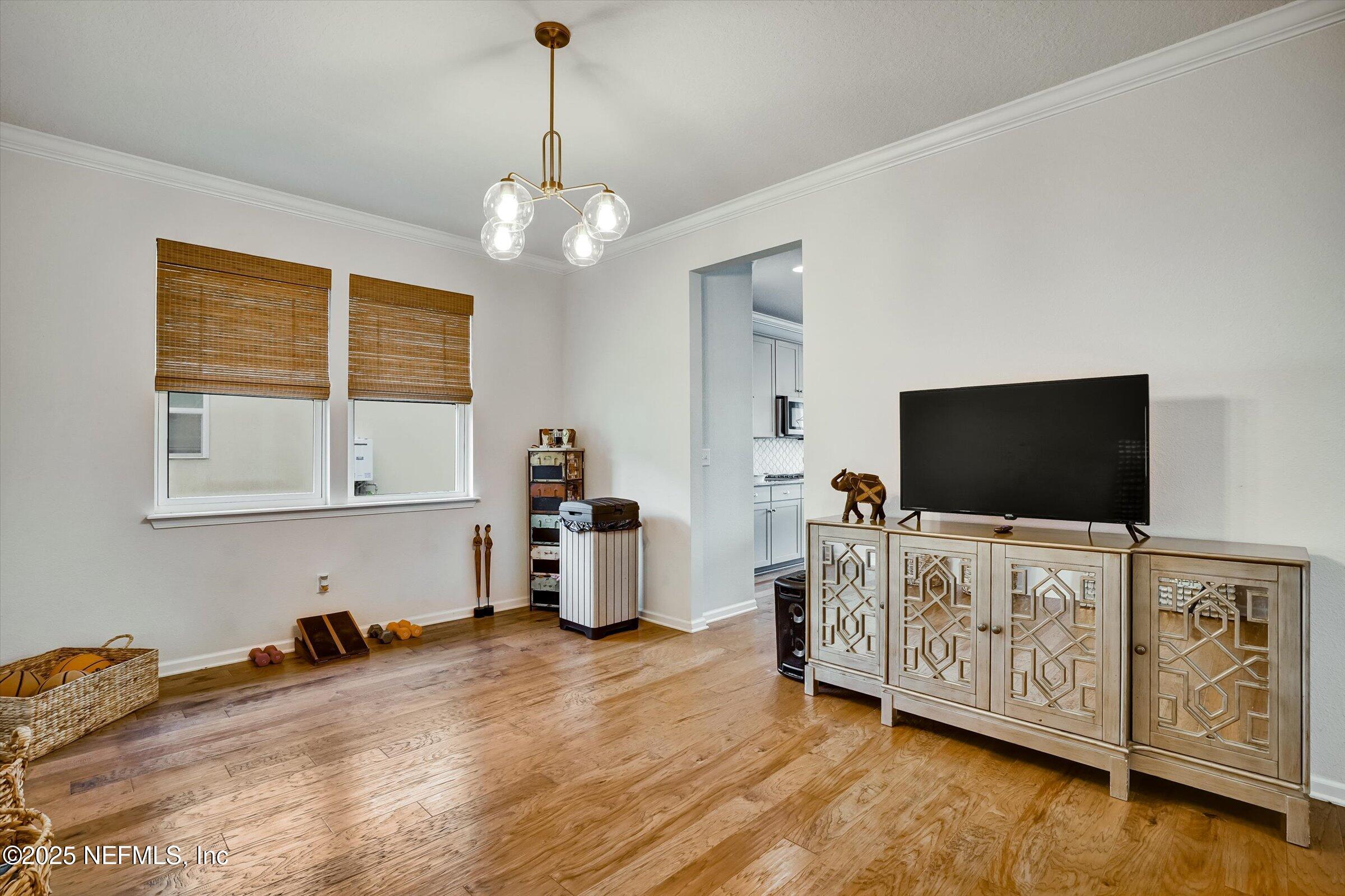 410 Downs Corner Road St. Augustine, FL 32092 - Photo 7 of 45 a bedroom with furniture and a flat screen tv