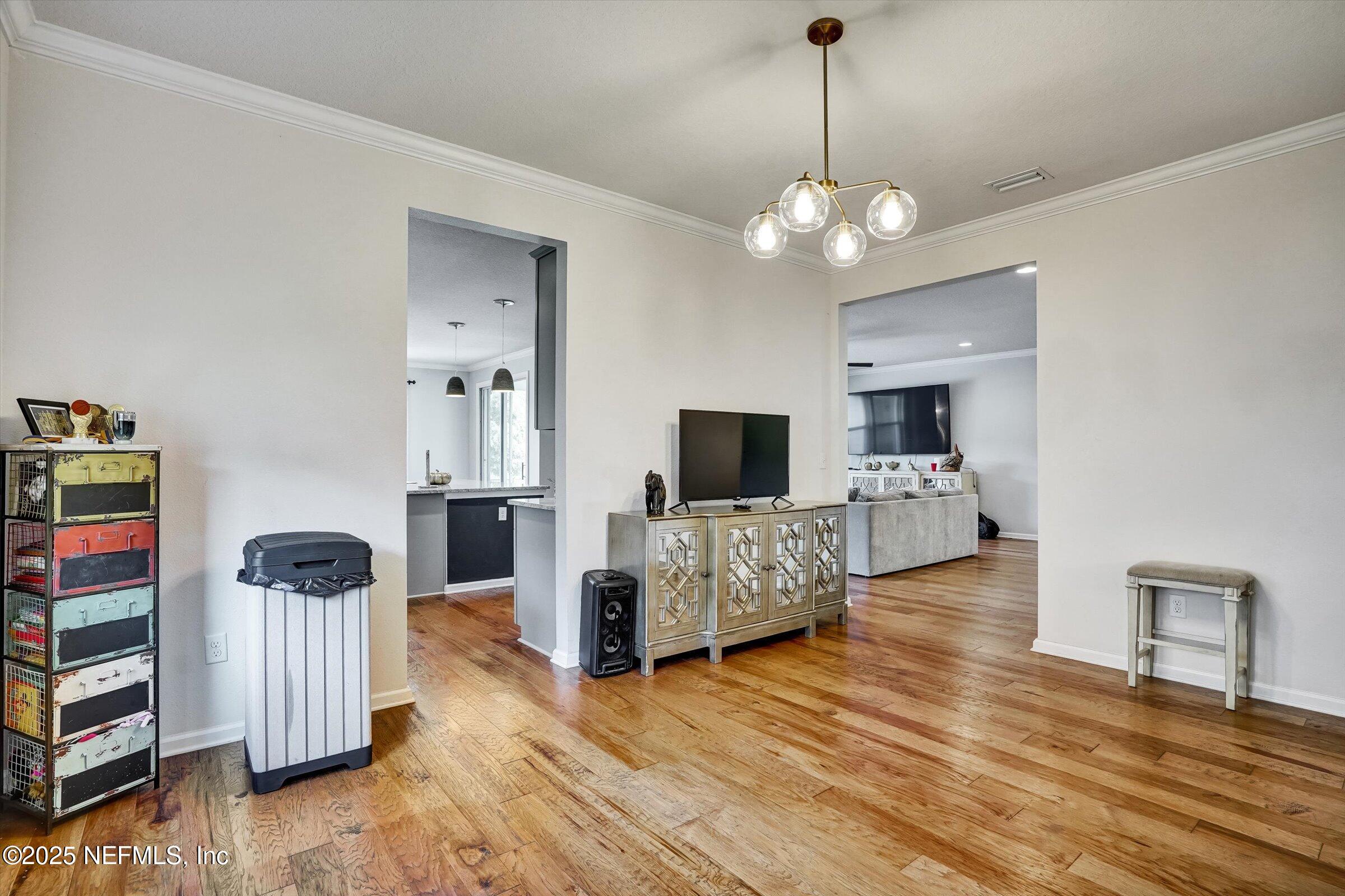 410 Downs Corner Road St. Augustine, FL 32092 - Photo 9 of 45 a living room with furniture and a flat screen tv