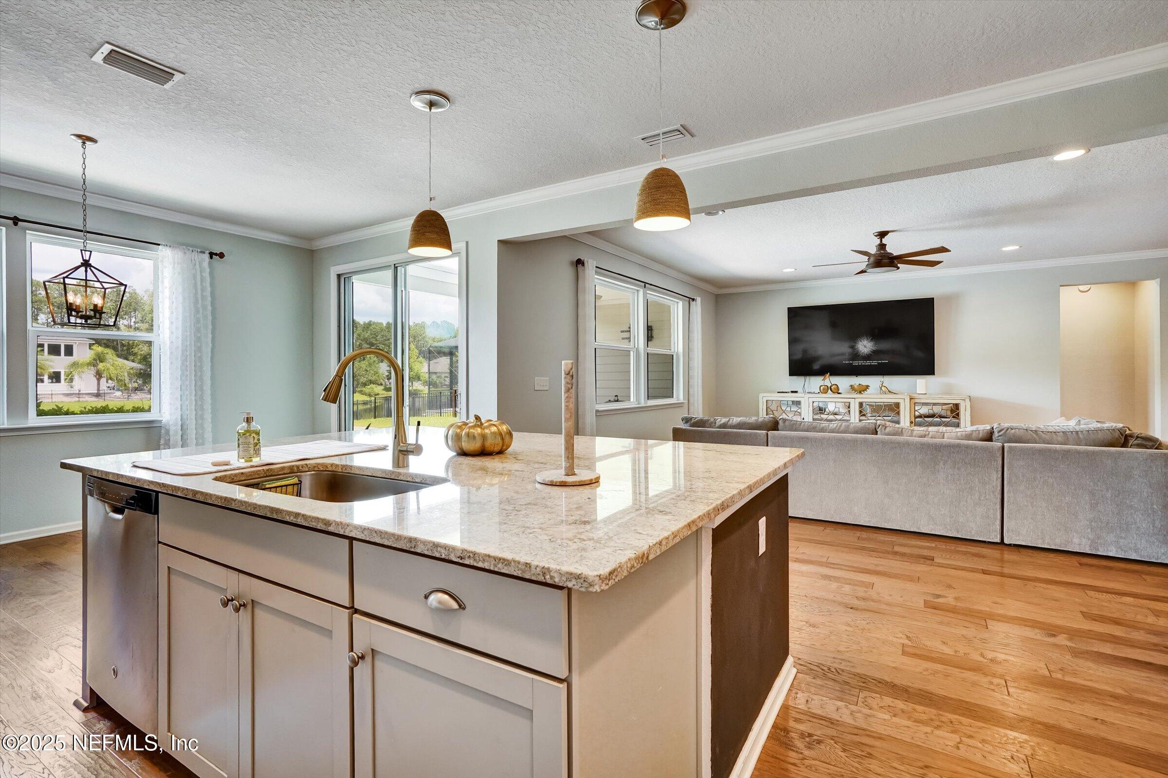 410 Downs Corner Road St. Augustine, FL 32092 - Photo 10 of 45 a kitchen with stainless steel appliances granite countertop a sink and a stove