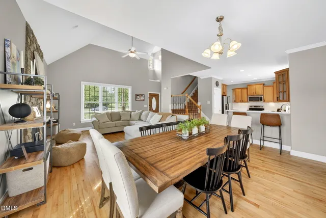 a view of a dining room with furniture a chandelier and wooden floor