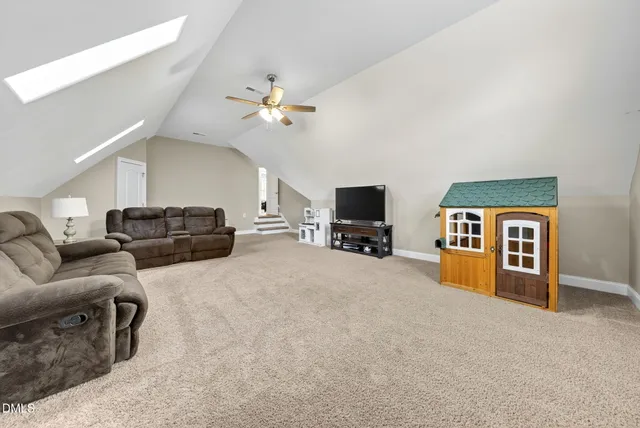 a living room with furniture flat screen tv and couches