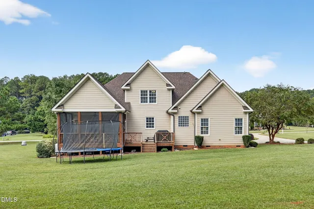 a view of a house with a yard and sitting area