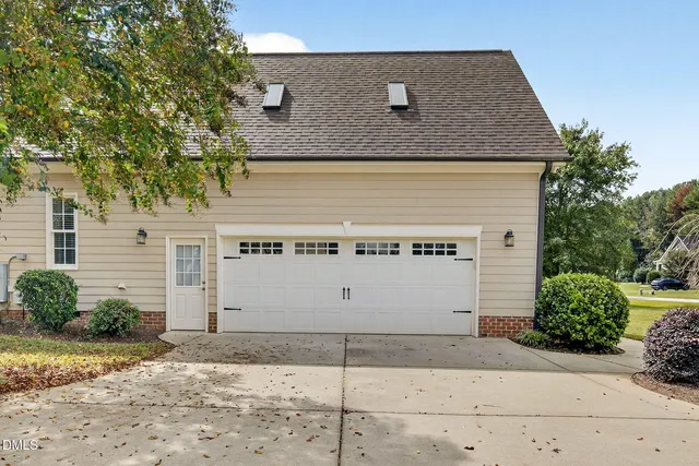 a view of a house with white fence