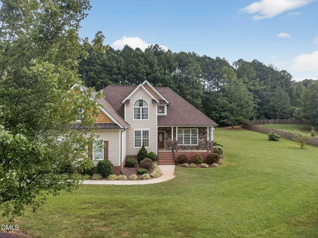 a front view of a house with a yard table and chairs