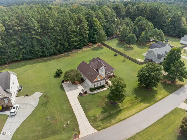 an aerial view of a house with a swimming pool