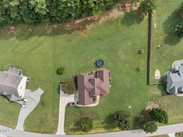 an aerial view of a house with a yard basket ball court and outdoor seating