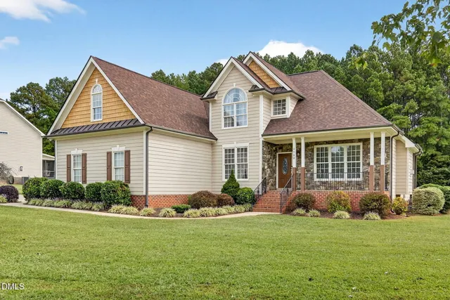 a view of a house with a yard and plants