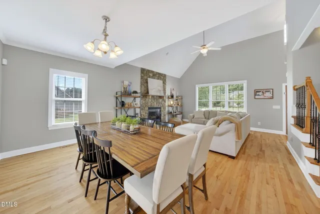 a view of a dining room with furniture a chandelier and wooden floor