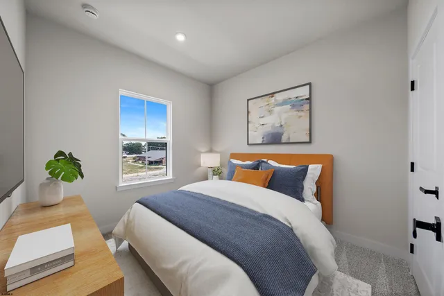 a bedroom with bed and window