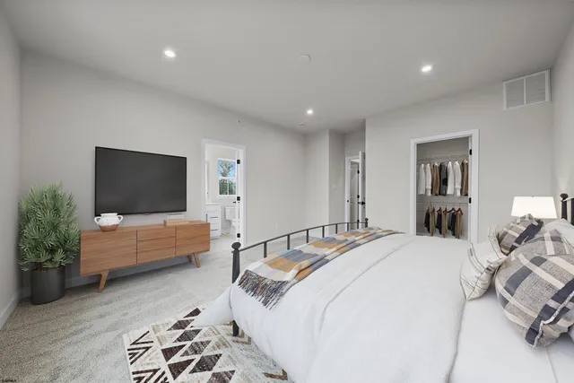 a bedroom with a bed and a couch