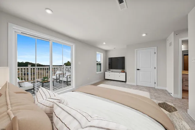 a bedroom with a bed and a television