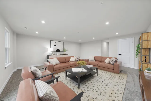 a living room with furniture and a rug