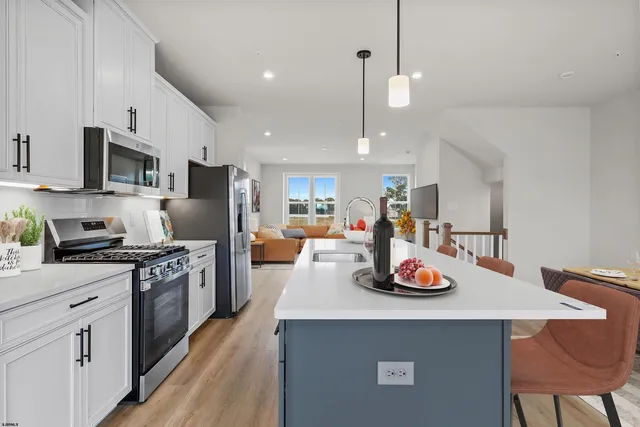 a kitchen with a sink a stove and chairs