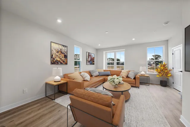 a living room with furniture and flowers