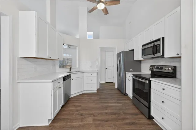 a kitchen with stainless steel appliances a refrigerator stove microwave and cabinets