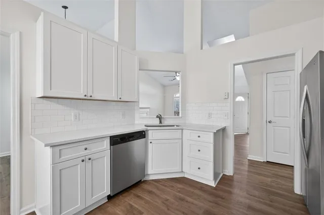 a kitchen with white cabinets and white appliances