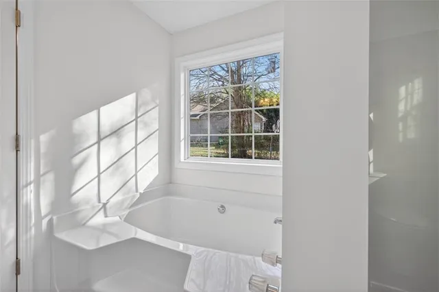 a bathroom with a bathtub and window