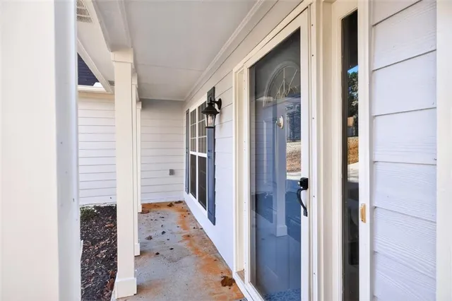 a view of a hallway with wooden floor and entryway